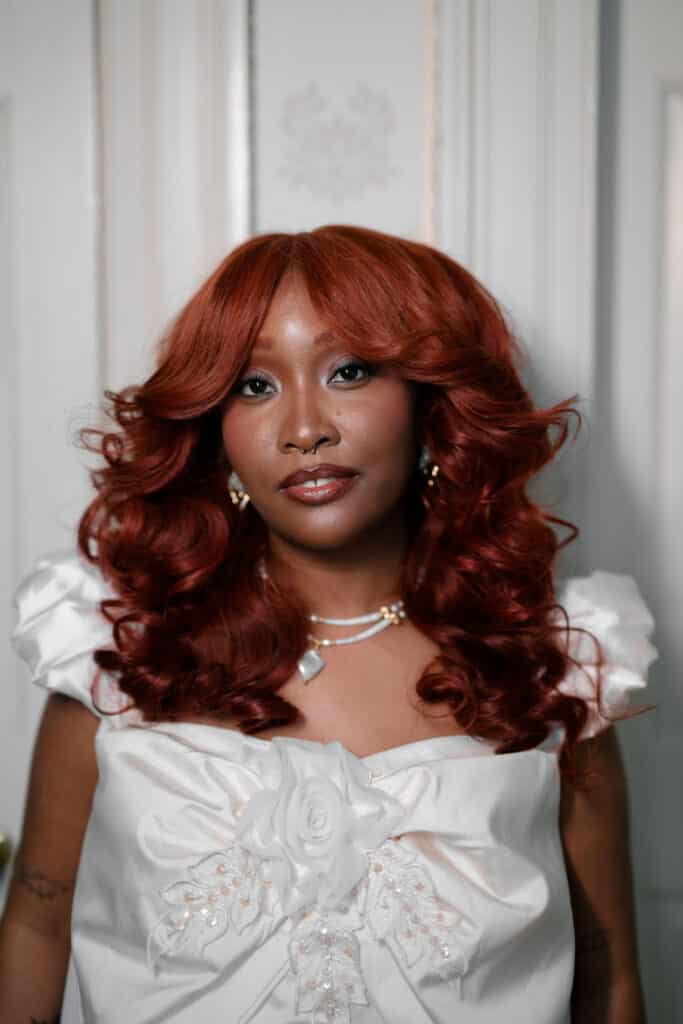 Woman with red curly hair, elegant dress