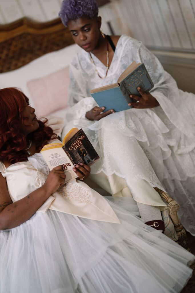 Two women reading books together.